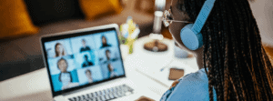 Woman With Headphones on In Video Session With a Career Coaching Company