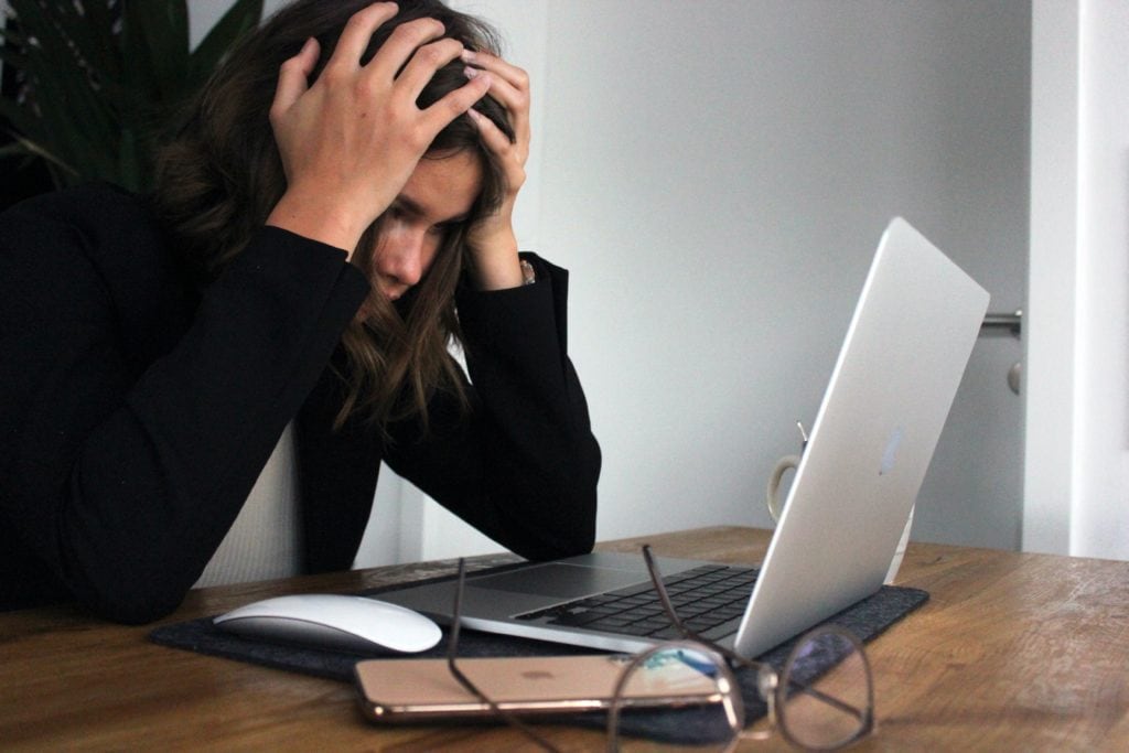 Woman at Computer With Hands on Head