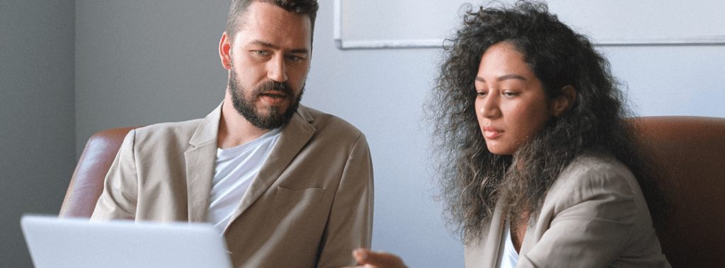 A man learning from his female business growth coach