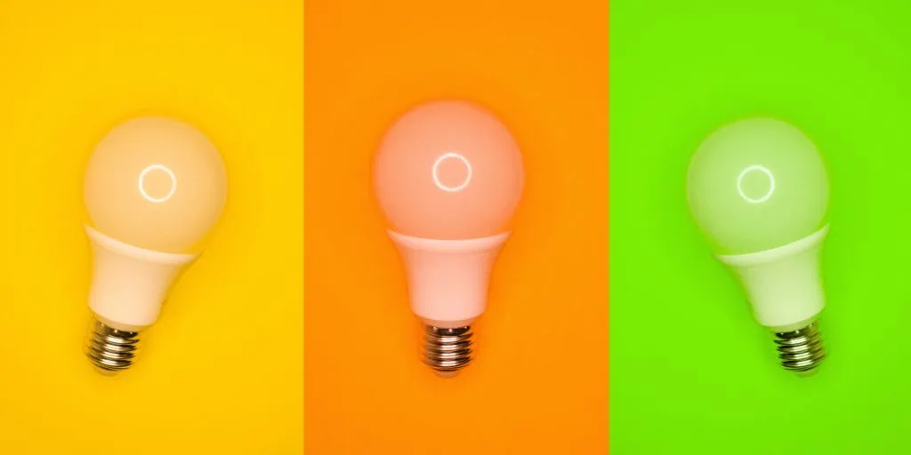 Still Life Photo of Three Light Bulbs on Different-Color Backgrounds