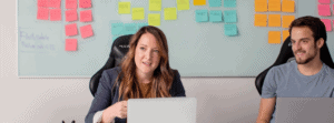 Woman Sitting In Front of Laptop In Meeting With Employees