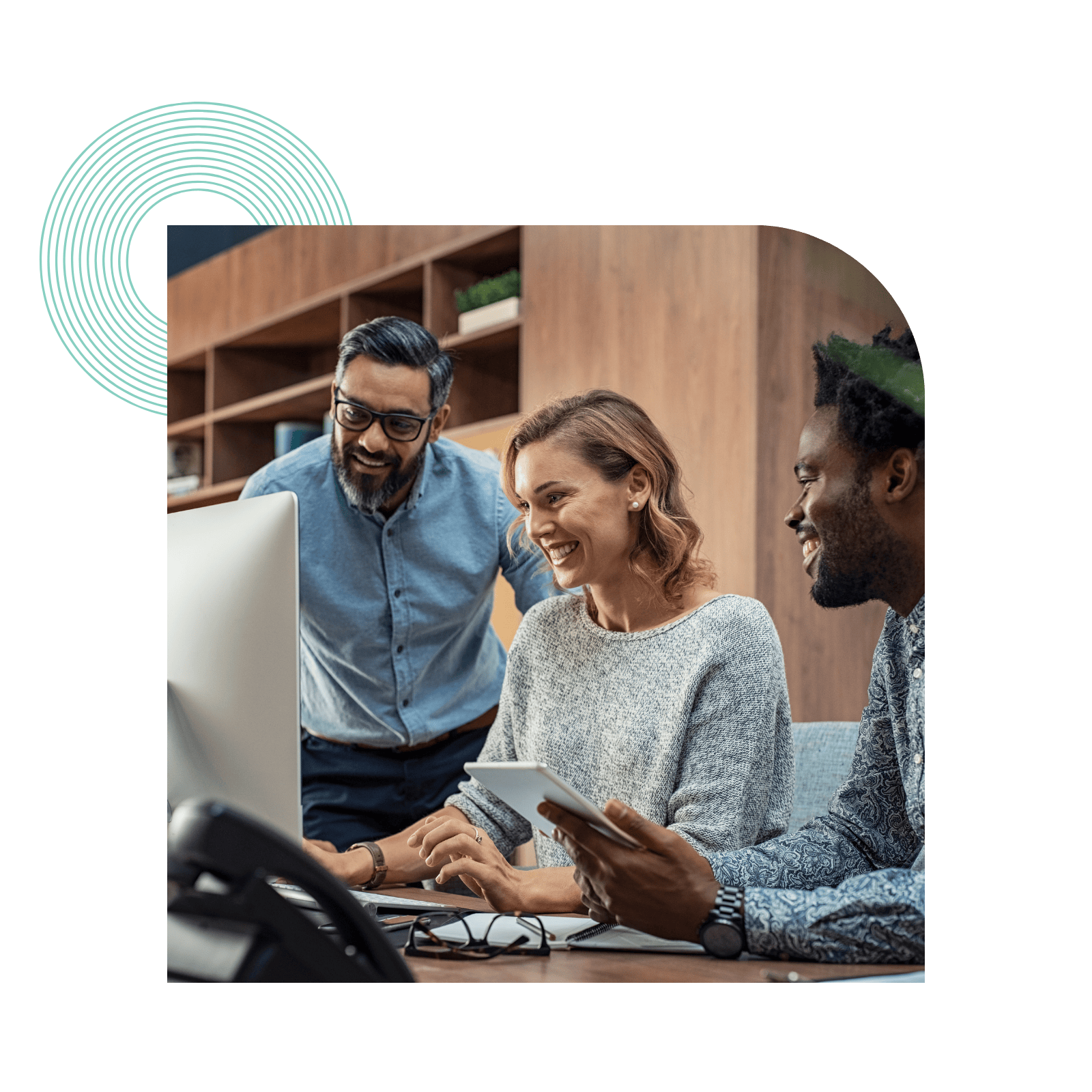 employees looking at computer together