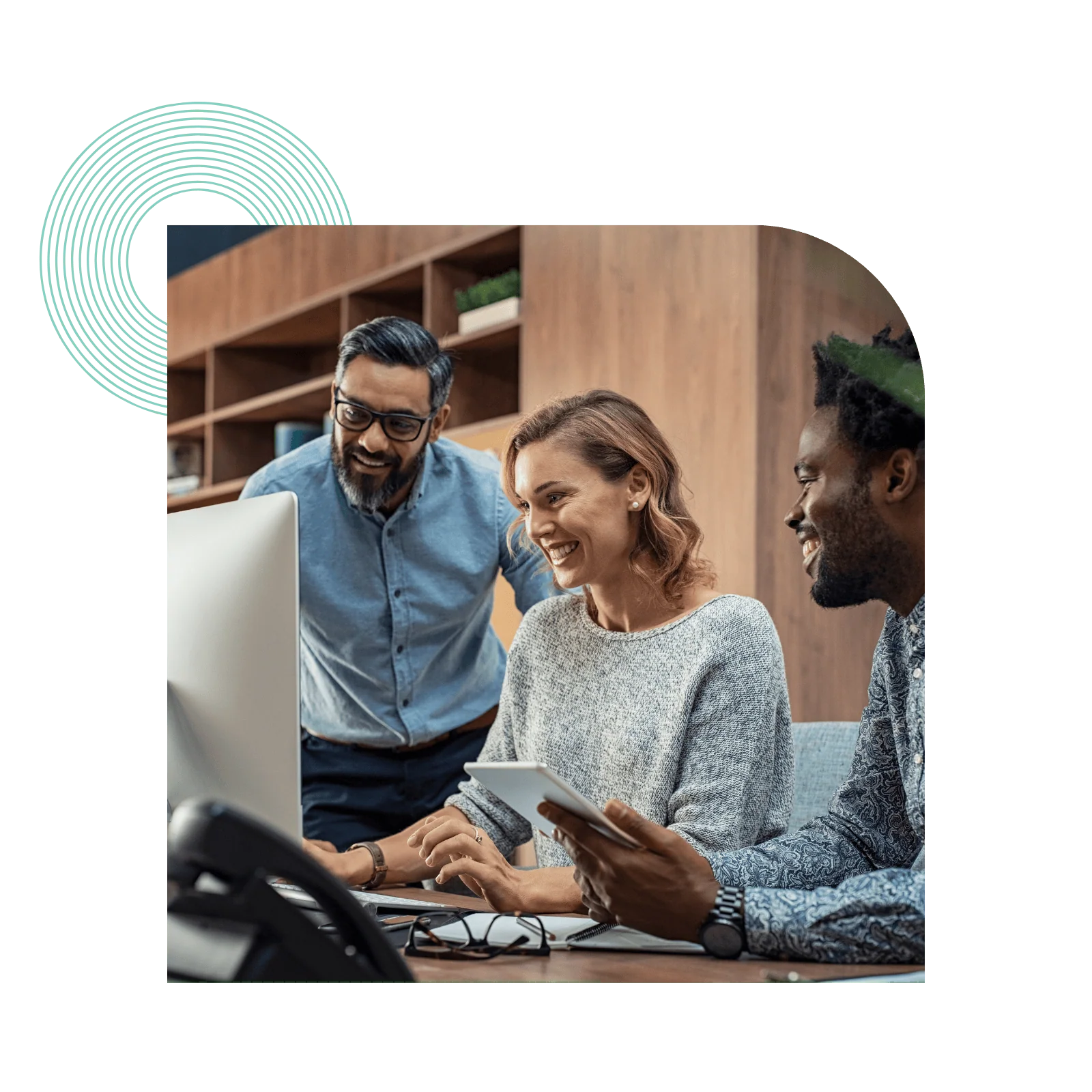 employees looking at computer together