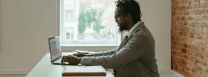 Man Working on Laptop In Virtual Work Environment