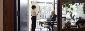 Manager Training Employee for Business Succession in Boardroom